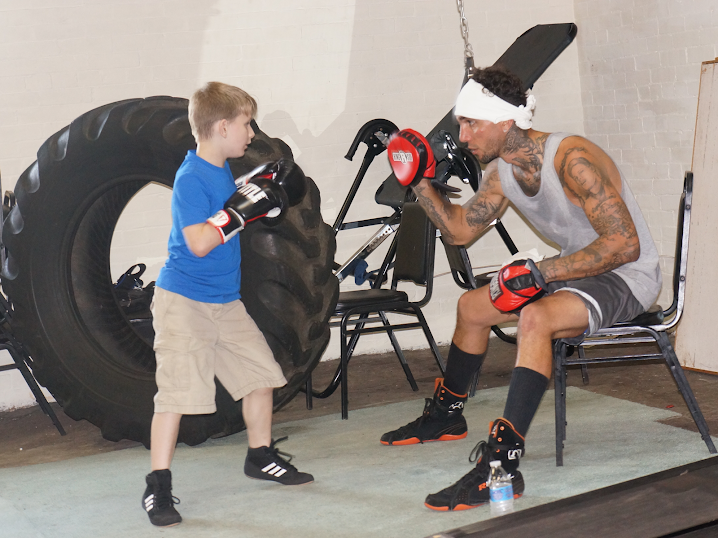 Coaching a young boxer on the mitts